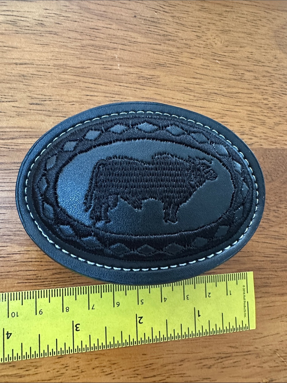Black Oval Leather & Embroidered Belt Buckle with Bull Motif.